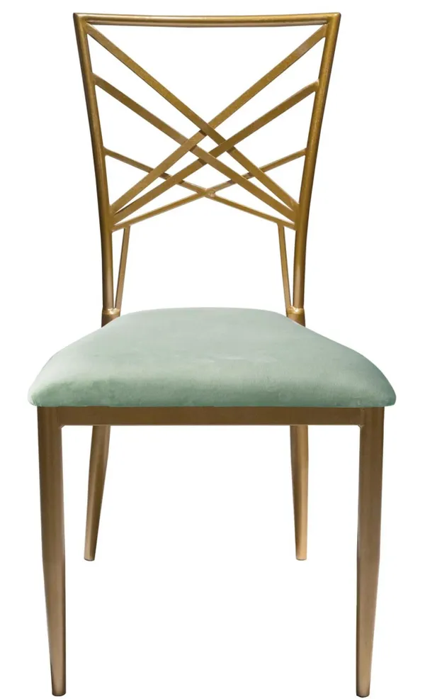 Gold lattice-back chair with a deep fern green velvet seat styled around an elegant round table with pearlescent plates and pistachio glasses.
