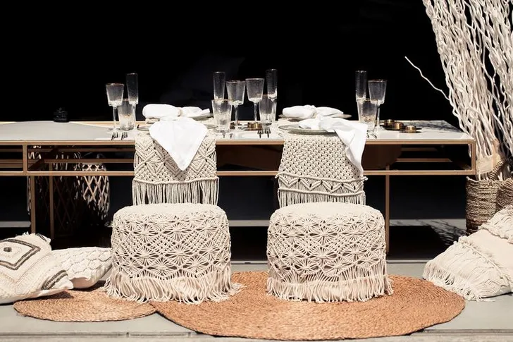 Beige boho table setting with ottomans
