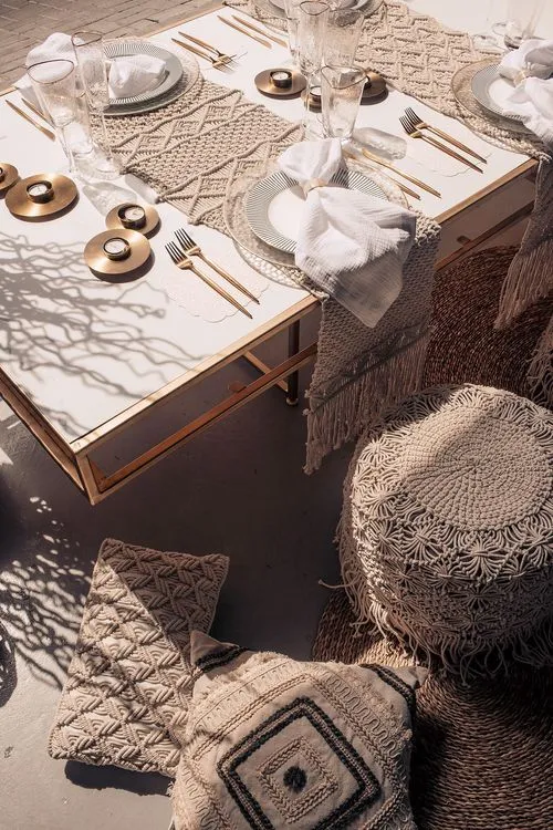 Beige boho table setting with ottomans