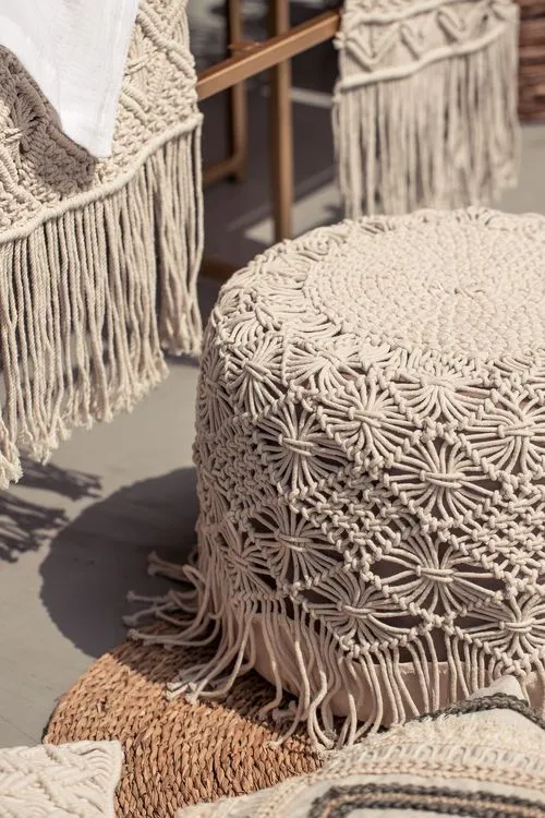 Beige boho table setting with ottomans