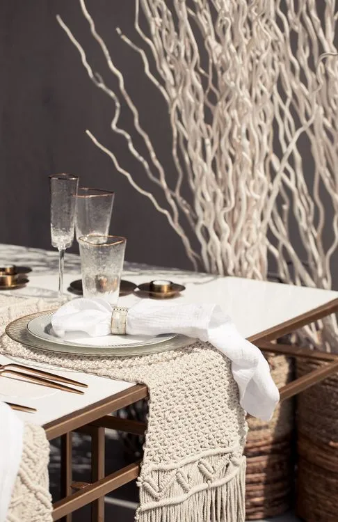 Beige boho table setting with ottomans