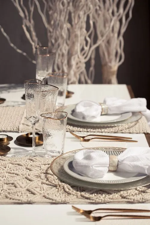 Beige boho table setting with ottomans
