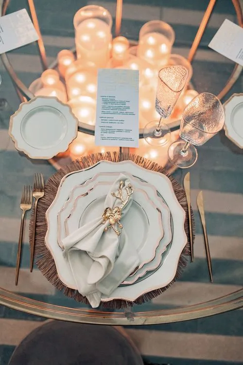 Beige candlelit table setting at round table