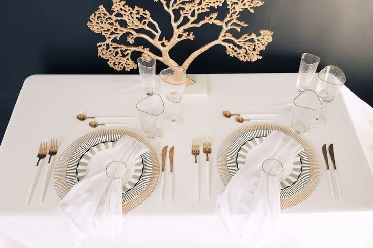 White set with gold accents on a rectangular table