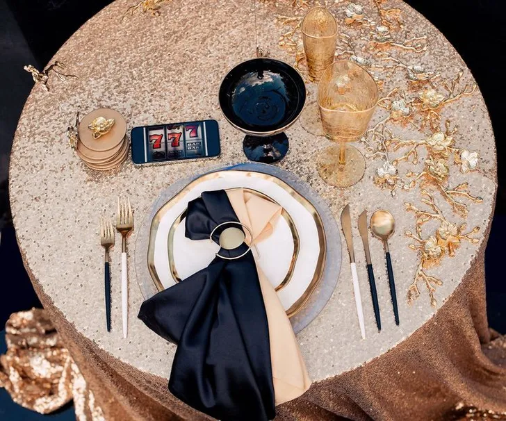 Black-gold table setting at round table