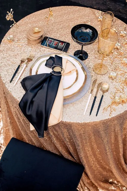 Black-gold table setting at round table