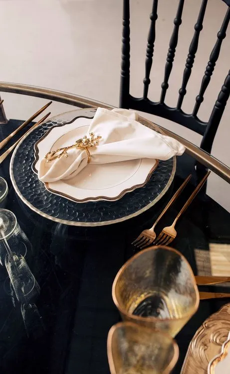 Black-white table setting with gold at round table