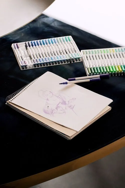Black and white serpentine tables with velvet poufs