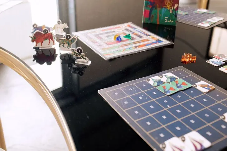 Black and white serpentine tables with velvet poufs