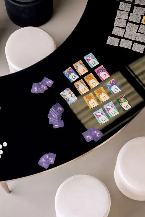 Black and white serpentine tables with velvet poufs