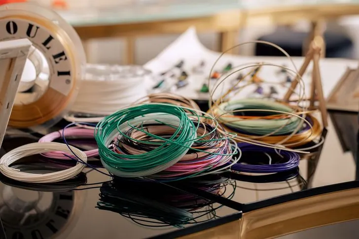 Black and white serpentine tables with velvet poufs