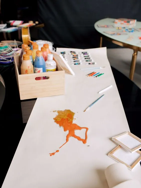 Black and white serpentine tables with velvet poufs
