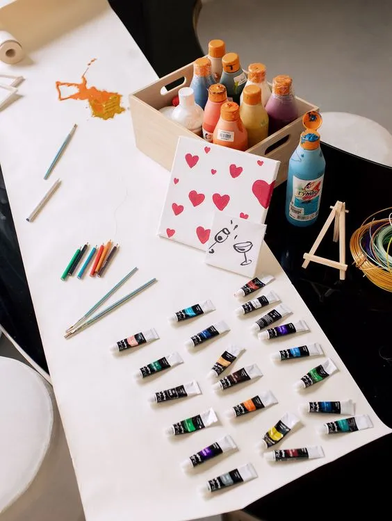 Black and white serpentine tables with velvet poufs