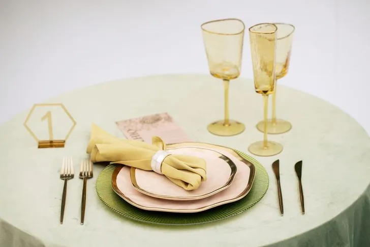 Green table setting with ottomans