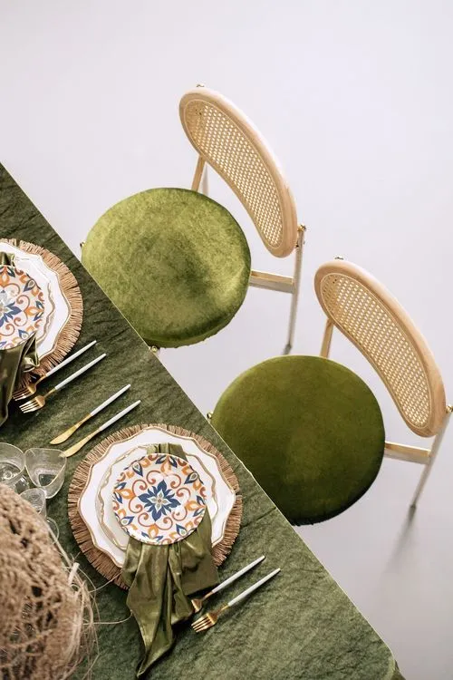 Green velvet tablescape rattan chairs