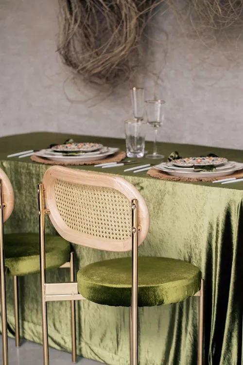 Green velvet tablescape rattan chairs