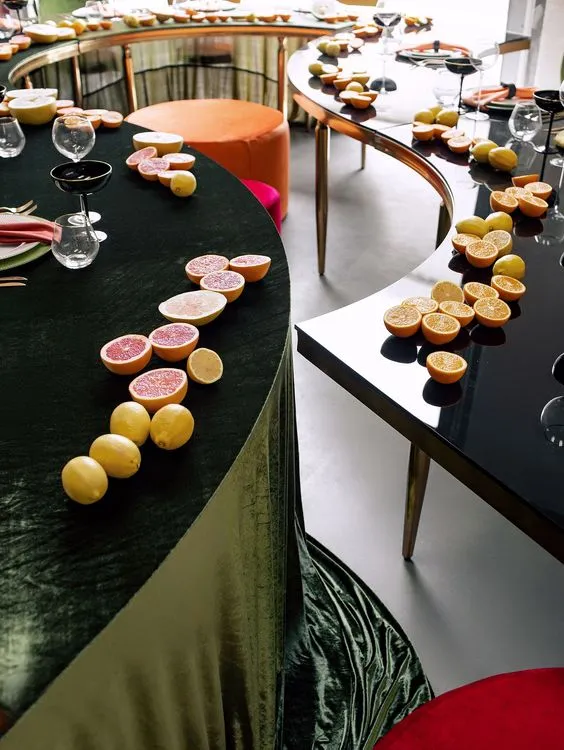 Orange green serpentine table set with poufs