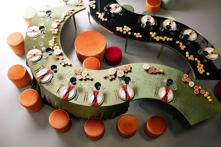 Orange green serpentine table set with poufs
