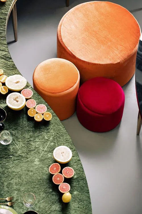 Orange green serpentine table set with poufs
