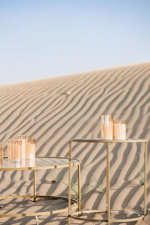 Pink desert lounge setup with ottomans