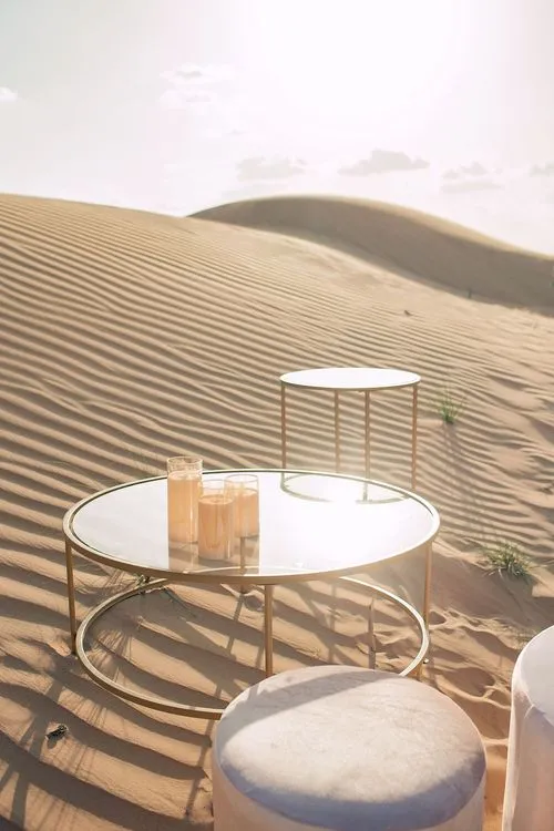 Pink desert lounge setup with ottomans