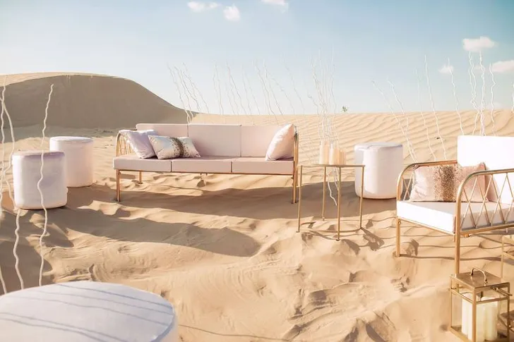 Pink desert lounge setup with ottomans