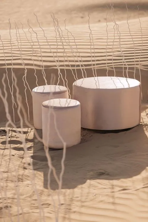 Pink desert lounge setup with ottomans