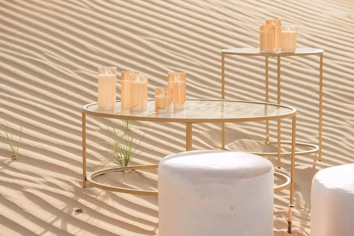 Pink desert lounge setup with ottomans