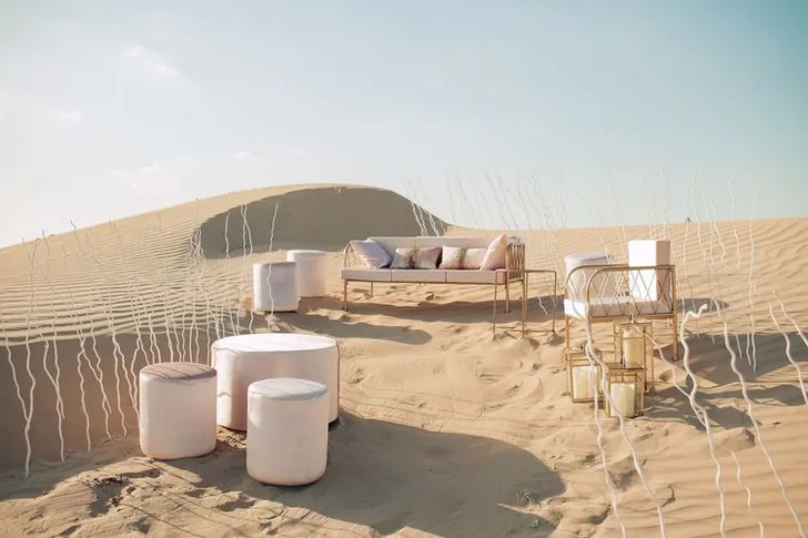 Pink desert lounge setup with ottomans