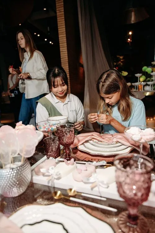 Pink kids party with velvet poufs