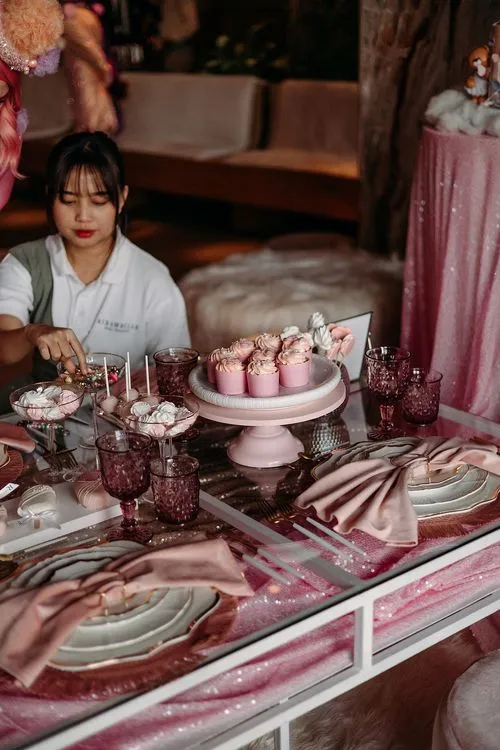 Pink kids party with velvet poufs