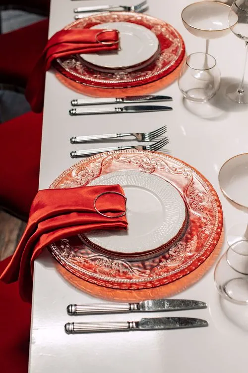 Red table setting at rectangular table