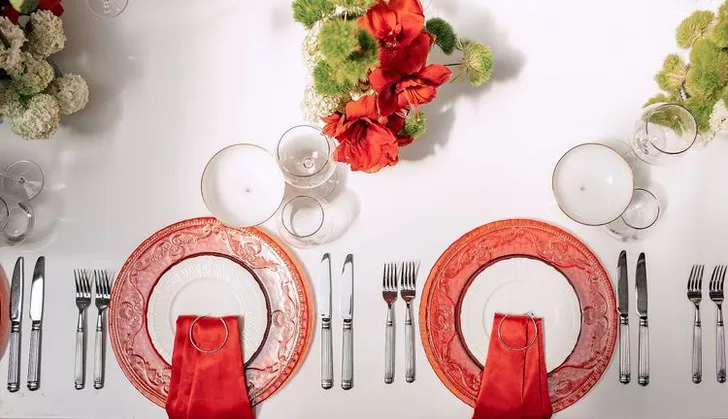 Red table setting at rectangular table