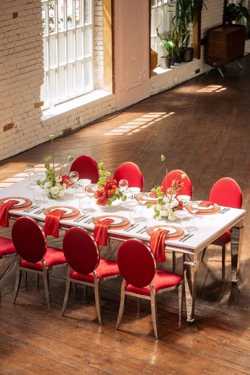 Red table setting at rectangular table