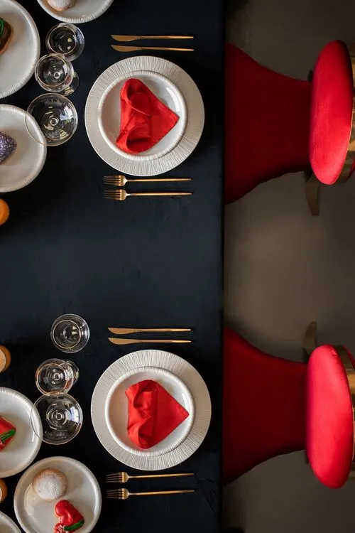 Red-black table setting at rectangular table