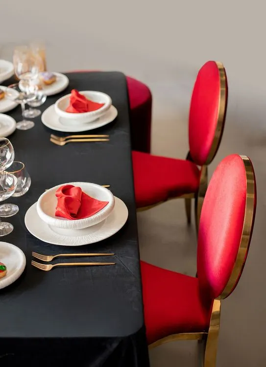 Red-black table setting at rectangular table