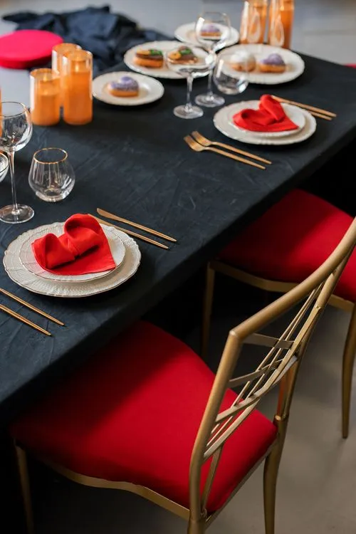 Red-black table setting at rectangular table