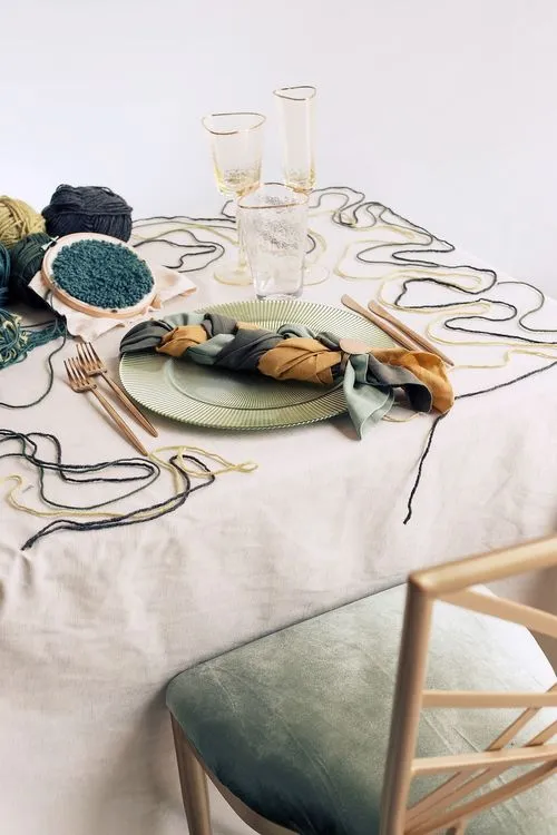 Soft green table setting with embroidery hoops