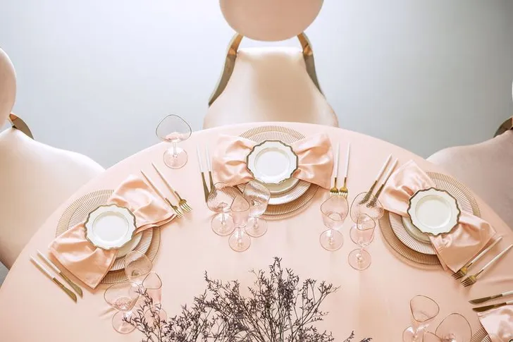 Soft pink table setting at round table