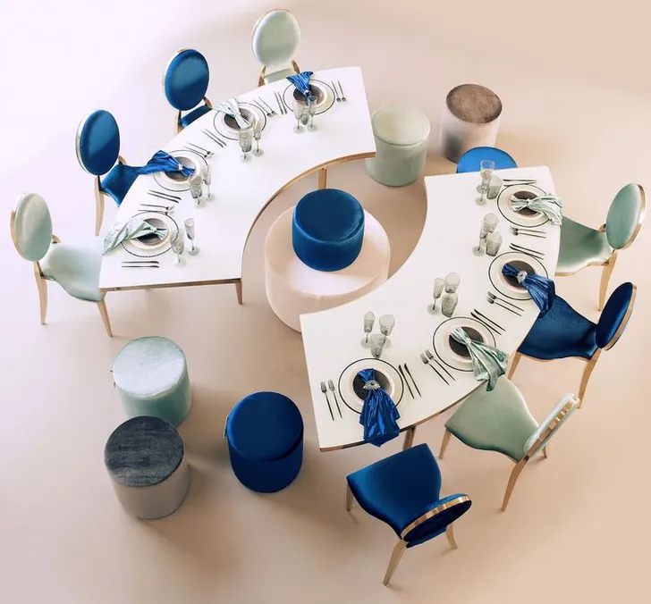 Eye-shaped table with a setup featuring blue accents