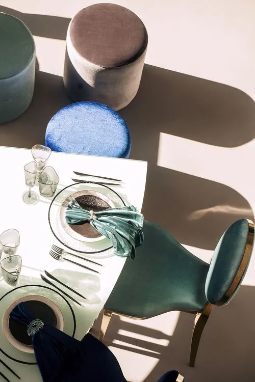 Eye-shaped table with a setup featuring blue accents