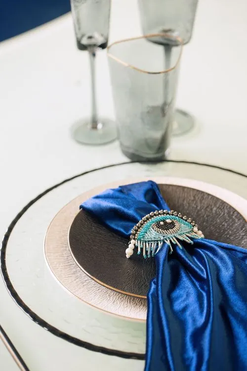 Eye-shaped table with a setup featuring blue accents