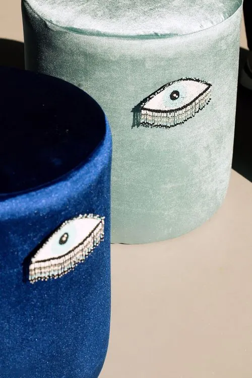 Eye-shaped table with a setup featuring blue accents