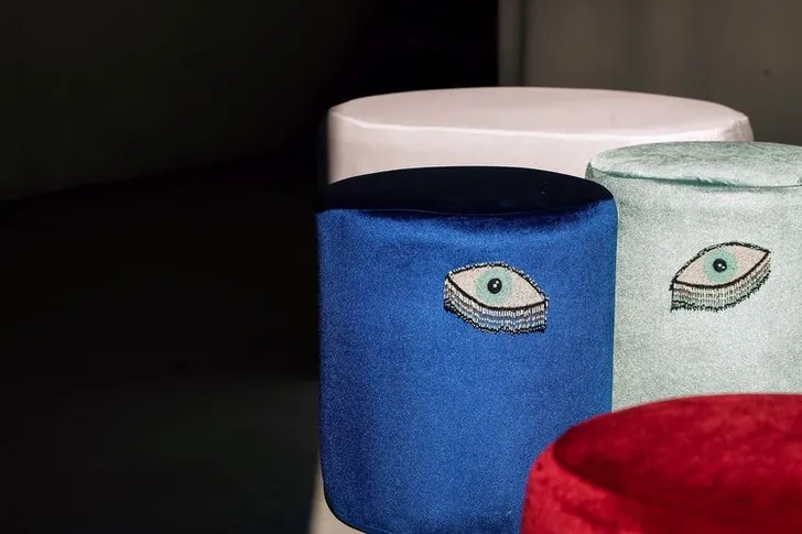 Eye-shaped table with a setup featuring blue accents