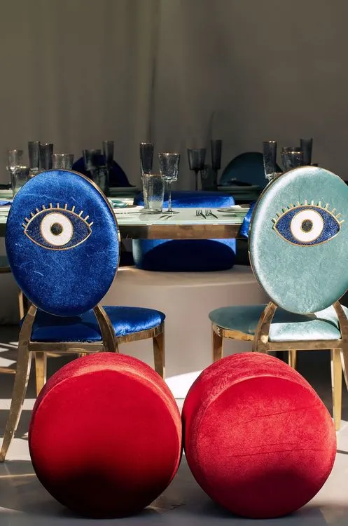 Eye-shaped table with a setup featuring blue accents