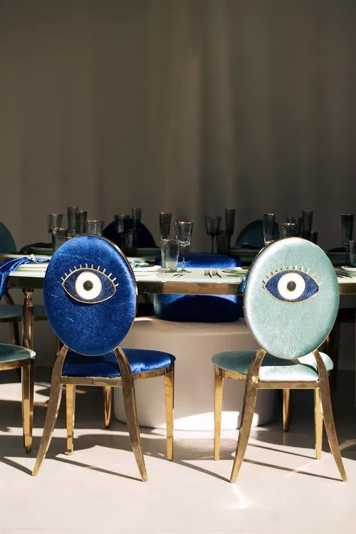 Eye-shaped table with a setup featuring blue accents