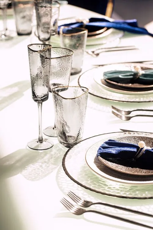Eye-shaped table with a setup featuring blue accents