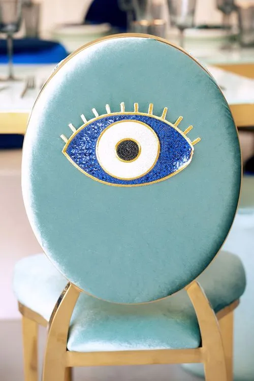Eye-shaped table with a setup featuring blue accents