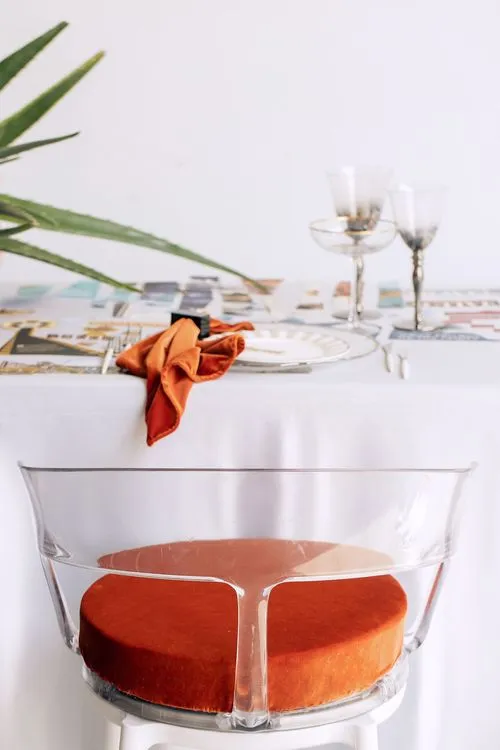 Table setting with orange accents at rectangular table