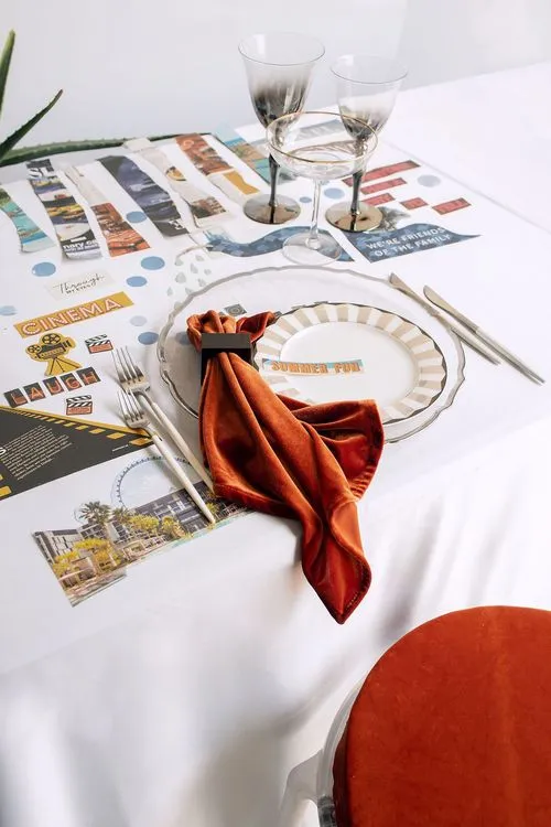 Table setting with orange accents at rectangular table